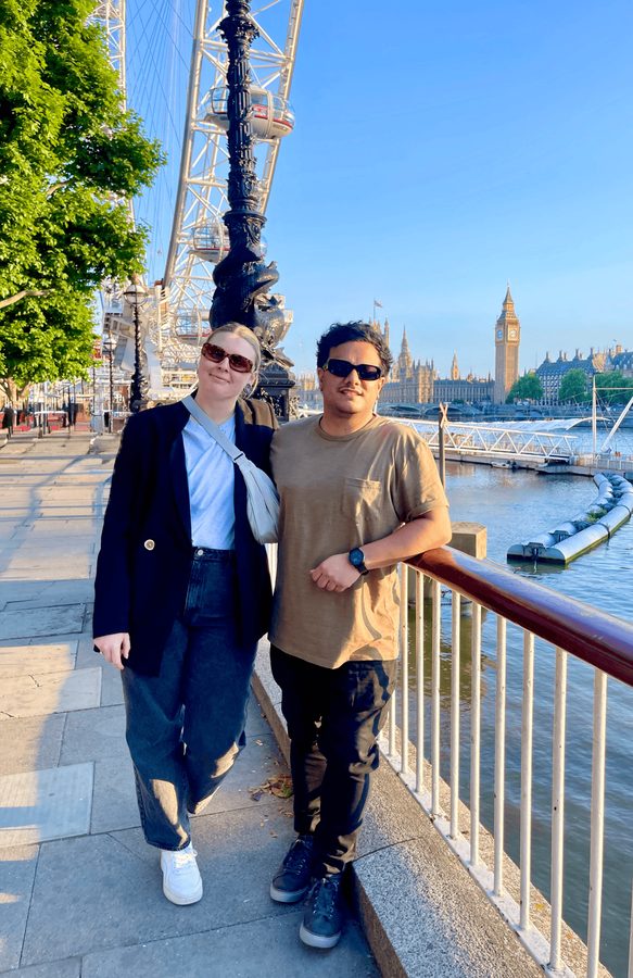 Zoe and Tyler beside the Thames in London